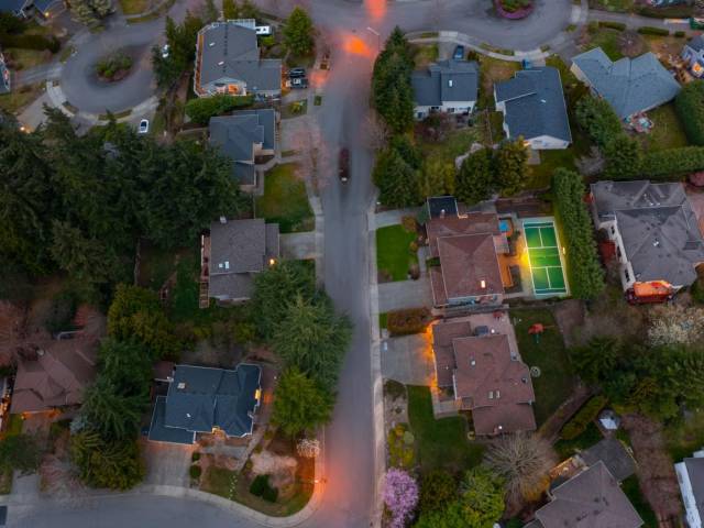 With tall hedges behind the home and backyard, you can keep your court lit way into the evening hours!