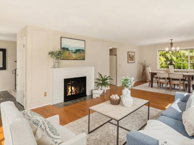 Generous living and dining area just off of the entrance. Cozy wood fireplace, all new paint and hardwood flooring.