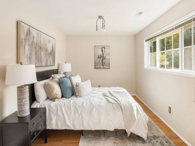 A smaller bedroom on the 2nd floor, the headboard wall shares with the large bedroom which could potential be removed and turned into the master suite.