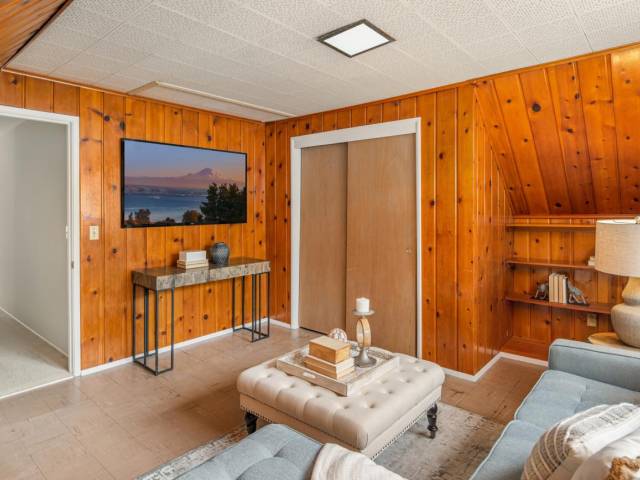 What we lovingly call the "Wood Room". Great bonus space but also a bedroom. Cedar lines the walls creating a rustic feel. Down a private hallway away from the rest of the home, this may be a great media center.
