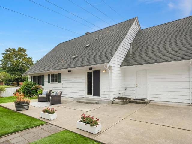 The patio with man door to garage area and plug for generator. The generator has it's own home just to the right of this picture with easy access and hook up. Plug it in and flip the switch on the electrical panel and remain comfortable no matter the