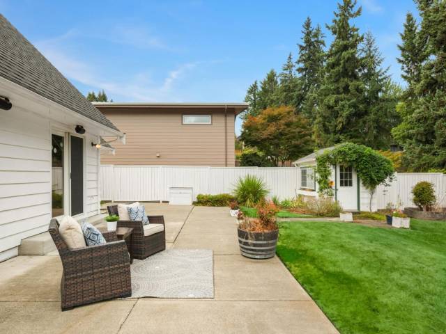 A well groomed and cared for back yard with plenty of patio space for entertaining.